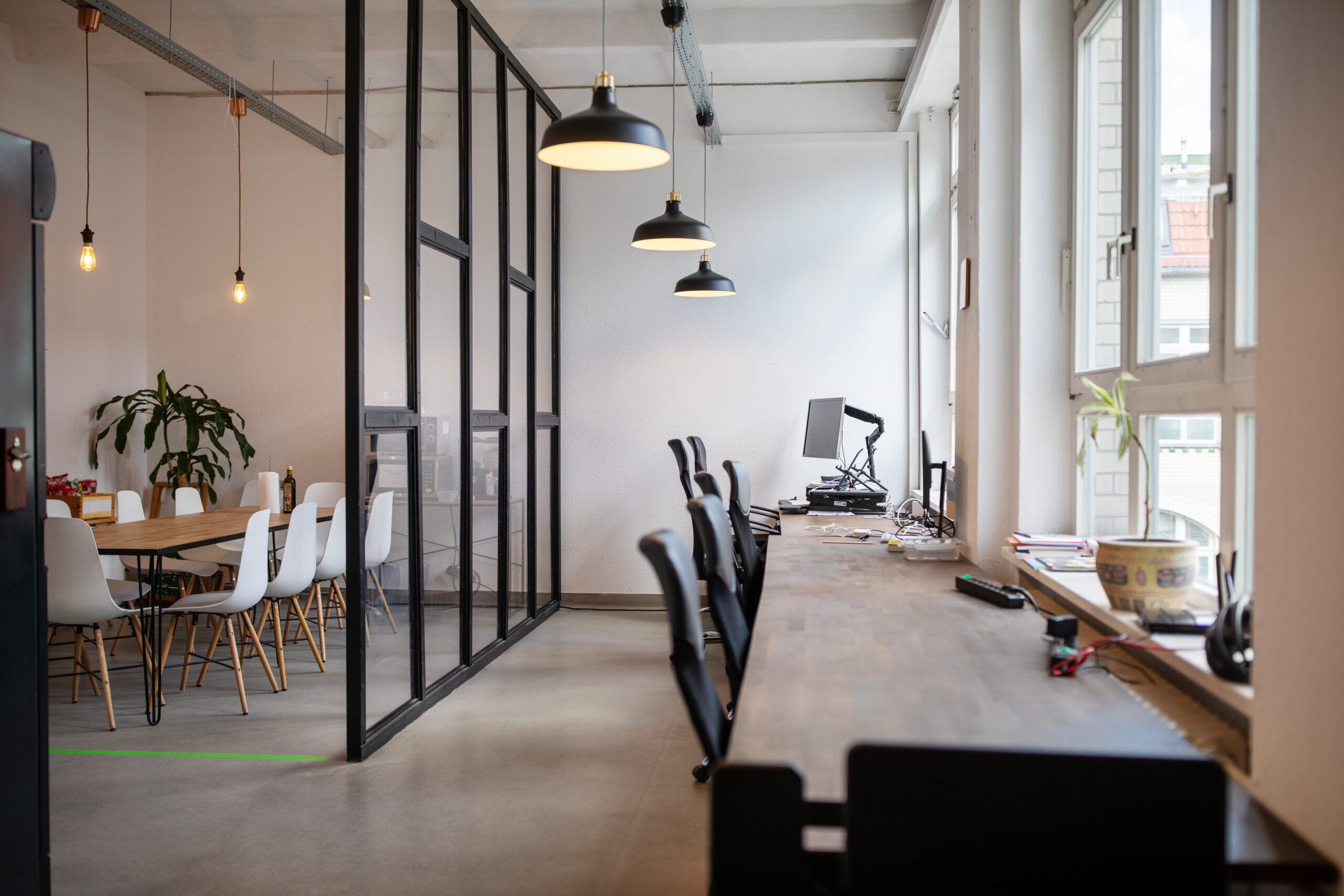 Creative workplace interior with over hanging lamps. Interior of coworking workplace.