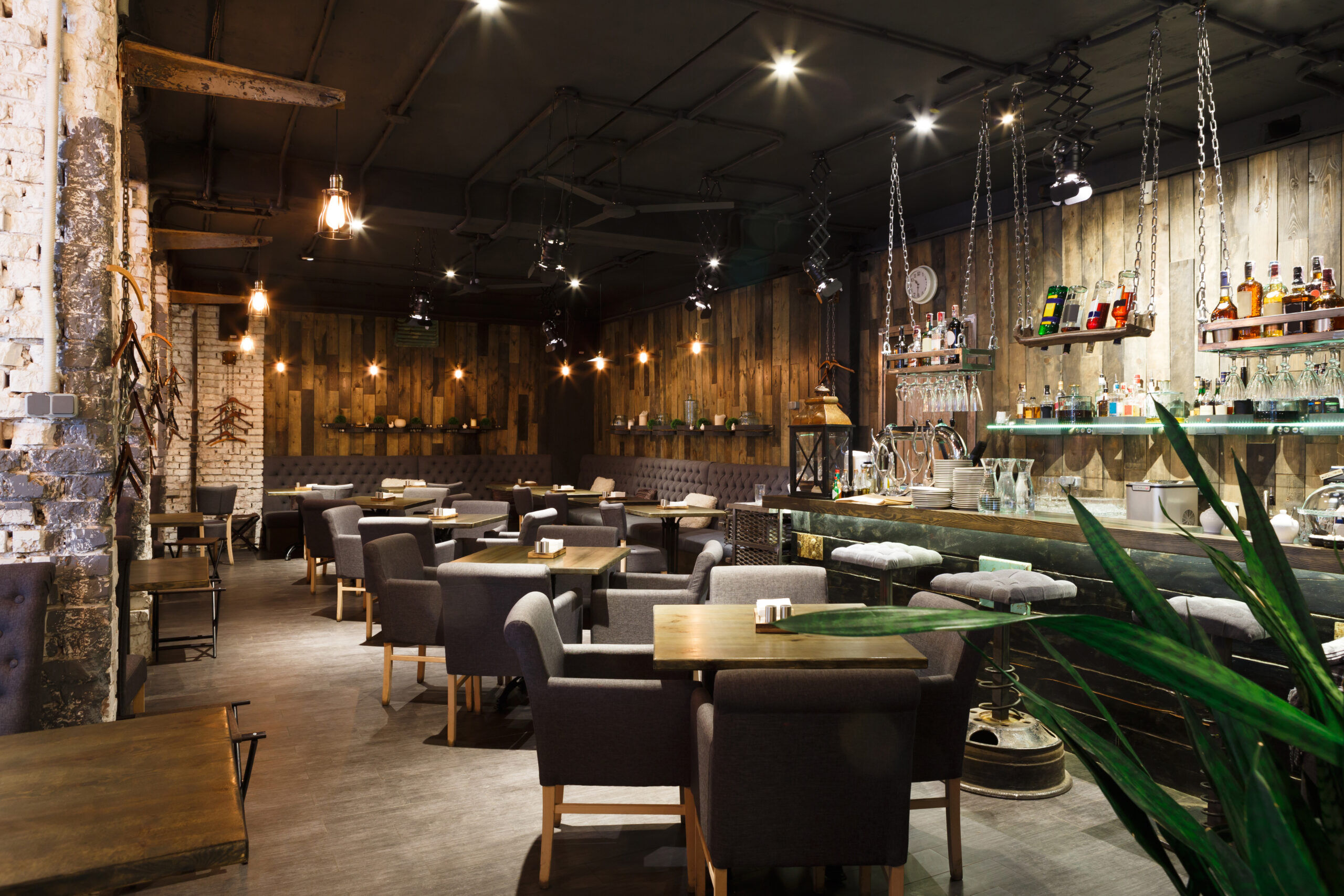 Interior of cozy restaurant. Contemporary design in loft style, modern dining place and bar counter, copy space